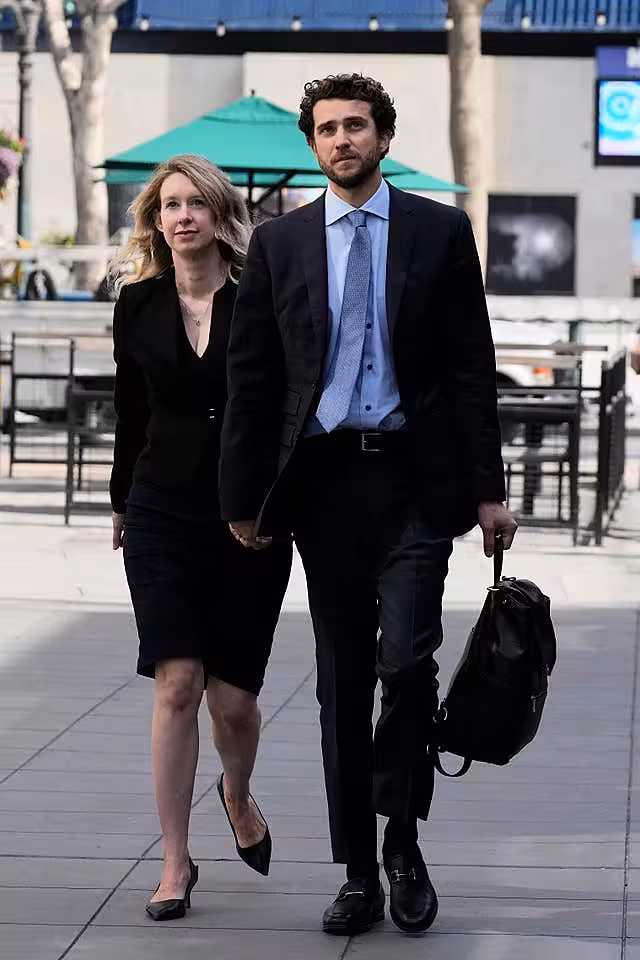 Holmes, left, and her partner, Billy Evans, leave federal court in San Jose, California, in March