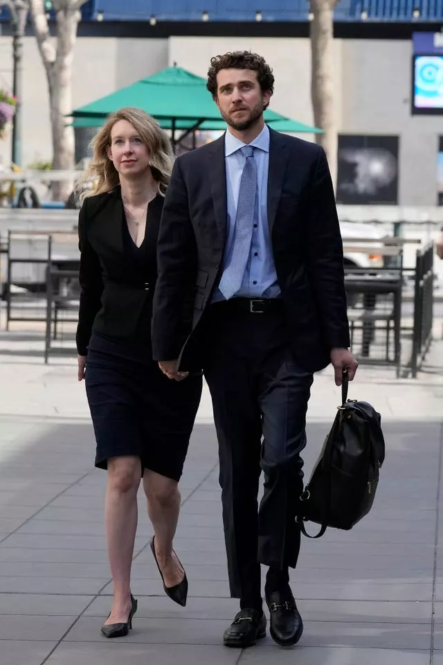 Holmes, left, and her partner, Billy Evans, leave federal court in San Jose, California, in March