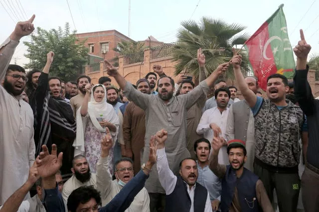 Supporters of Pakistan’s former prime minister Imran Khan’s party chant anti-government slogans during a demonstration against the police operation outside their leader’s residence, in Peshawar, Pakistan 