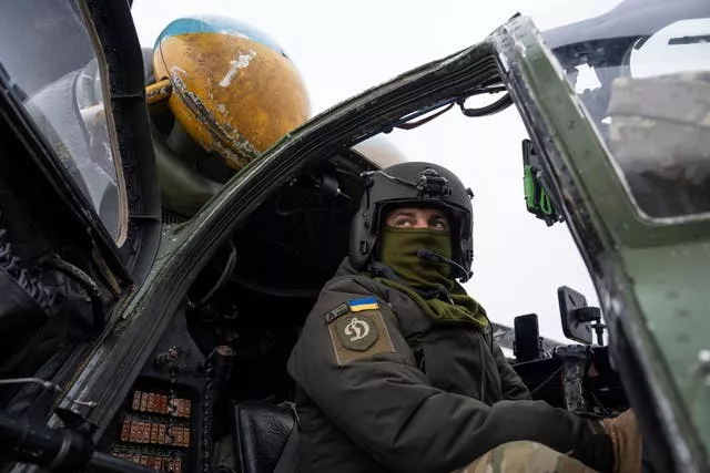 A Ukrainian pilot prepares for a flight on his Mi-24 attack helicopter during during a combat mission in Donetsk region, Ukraine