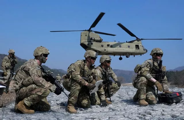 US Army soldiers wait to board their CH-47 Chinook helicopter during a joint military drill with South Korea and the United States in Pocheon, South Korea, Sunday, March 19, 2023 (Ahn Young-joon, File/AP)