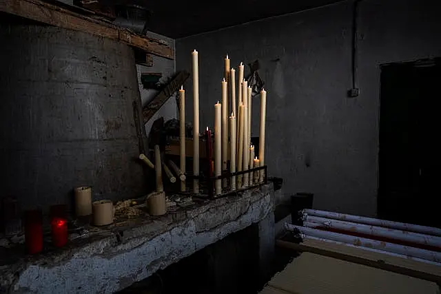 Candles burn at the Bellido candle factory in Andujar, southern Spain