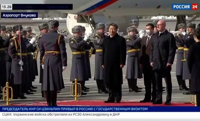 In this grab taken from video provided by RU-24, China’s President Xi Jinping stands, during an official welcome ceremony upon his arrival at the Vnukovo-2 government airport outside Moscow