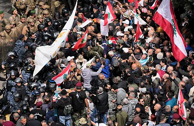 Retired army soldiers and other protesters clash with Lebanese army and riot police in Beirut 