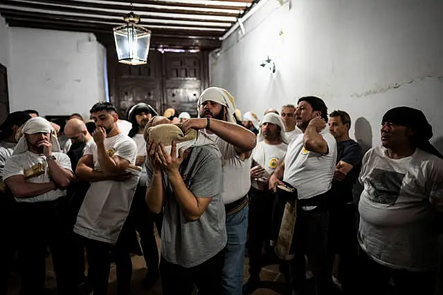 Porters of ‘Nuestro Padre Jesus del Gran Poder y la Esperanza Macarena’ brotherhood gather prior to practicing in downtown Madrid