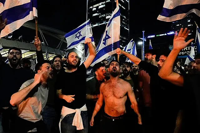 Israelis opposed to Prime Minister Benjamin Netanyahu’s judicial overhaul plan block a motorway during a protest moments after the Israeli leader fired his defence minister, in Tel Aviv, Israel