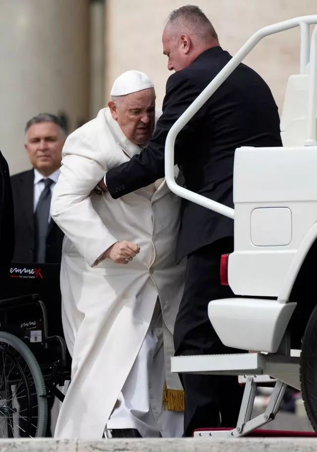 Pope Francis is helped to get into his car at the end of the weekly general audience in St Peter’s Square, at the Vatican, on Wednesday March 29 2023