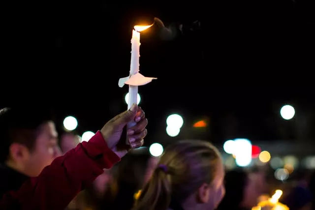 A candle is lifted into the air during the vigil