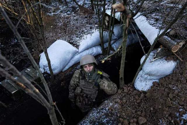 A Ukrainian serviceman smokes a cigarette from his position on the frontline near Bakhmut, Donetsk region, Ukraine