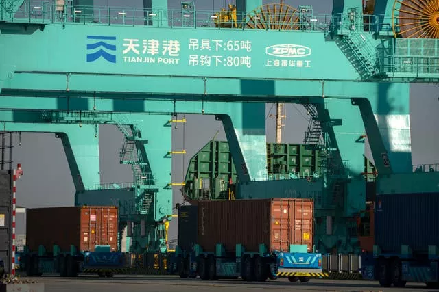Driverless trucks move shipping containers at a port in Tianjin, China