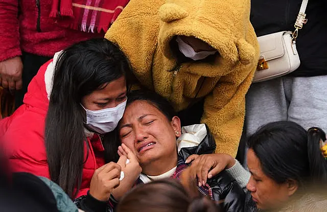 A woman cries as she waits to receive the body of a relative at a hospital in Pokhara, Nepal