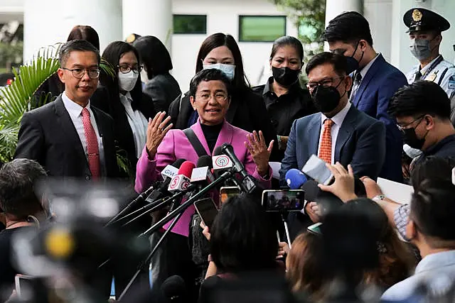 Filipino journalist Maria Ressa, center, one of the winners of the 2021 Nobel Peace Prize and Rappler CEO, speaks to the media after a court decision at the Court of Tax Appeals in Quezon City, Philippines Wednesday, Jan. 18, 2023. 