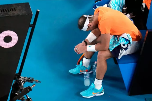 Rafael Nadal hangs his head after suffering a hip injury