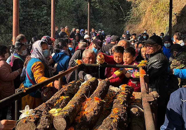 Relatives and friends perform last rites in Pokhara, Nepal