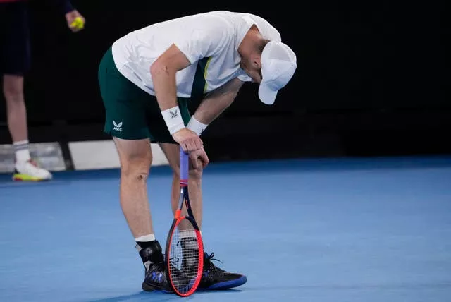 Andy Murray leans on his racket after losing a point