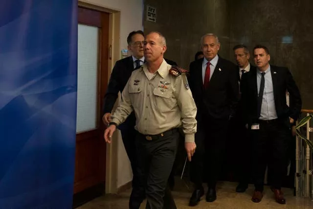 Mr Netanyahu, centre, arrives to chair the Cabinet meeting 