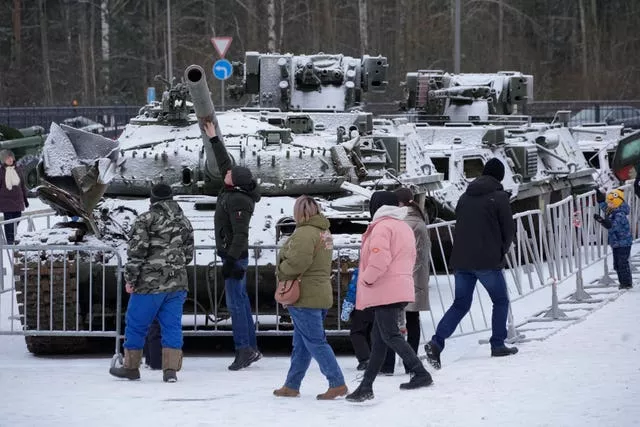 People visit an exhibition of tanks and armoured personnel carriers of Ukrainian armed forces damaged and captured during the fighting at an exhibition in Kirovsk in Russia 
