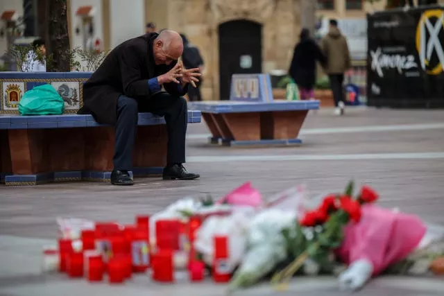A man reacts next to a memorial site for a church sacristan who was killed in Algeciras, southern Spain 