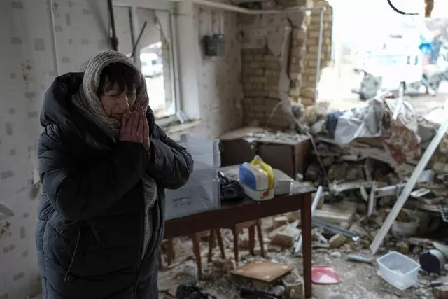 Halina Panasian, 69, reacts inside her destroyed house after a Russian rocket attack in Hlevakha, Kyiv region, Ukraine 