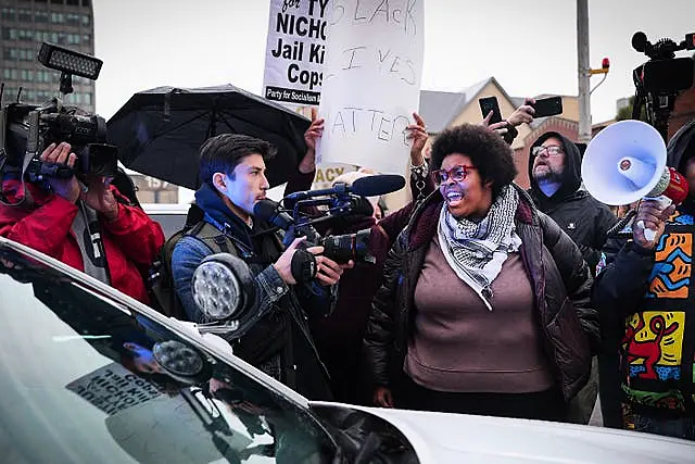 Activists momentarily surround an MPD cruiser during a march for Tyre Nichols