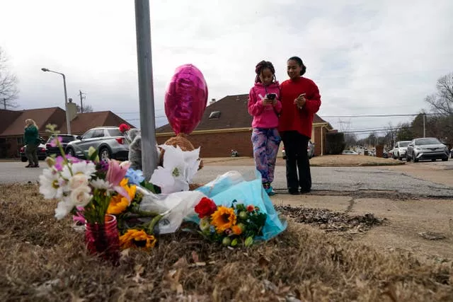 Shontae Handy and her daughter, Journee Askew, visit a makeshift memorial where Tyre Nichols was beaten by police and later died, at Bear Creek Cove and Castlegate Lane in Memphis