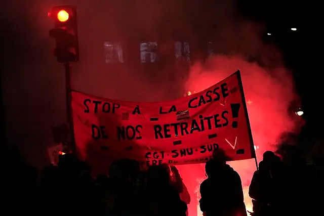 Protesters hold a banner demanding to stop plans to push back France’s retirement age, during a demonstration in Paris 