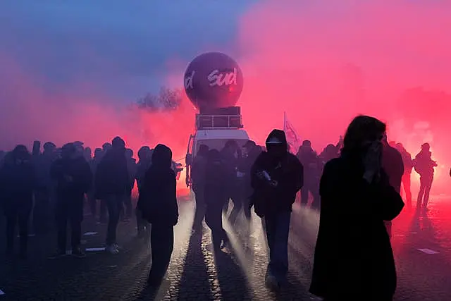 Demonstrators arrive near the Invalides monument during a demonstration against plans to push back France’s retirement age in Paris