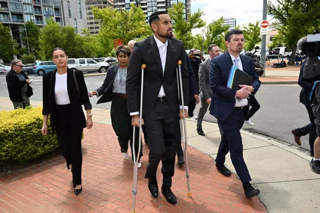 Australian tennis player Nick Kyrgios arrives on crutches at the ACT Magistrates Court in Canberra