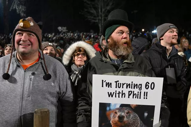 Rory Szwed, left, and Kent Rowan watch the festivities while waiting for Punxsutawney Phil