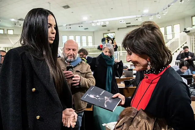 Karima El Mahroug presents her book to prosecutor Tiziana Siciliano, right 