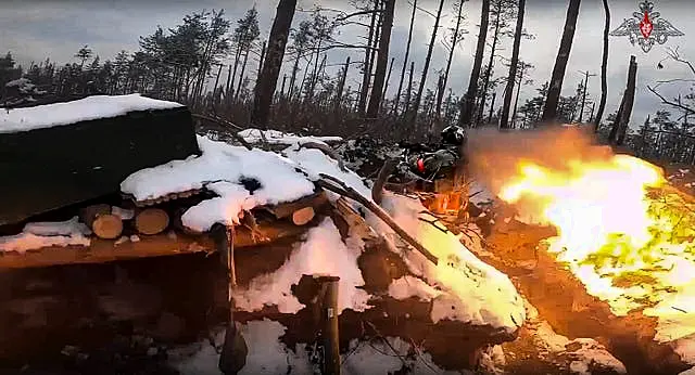 A Russian paratrooper fires a Russian man-portable missile on a mission at an unspecified location in Ukraine 