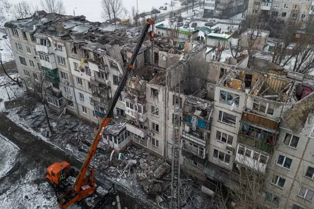 Rescue workers clear the rubble of a residential building destroyed by a Russian rocket in Pokrovsk, Ukraine 