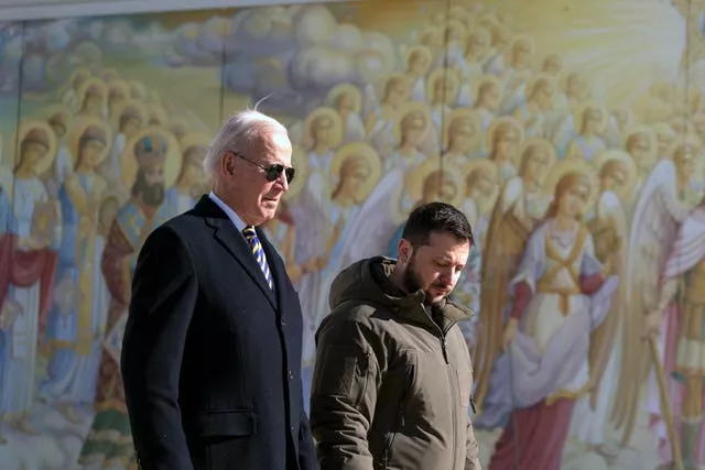 Joe Biden, left, walks with Ukrainian President Volodymyr Zelensky
