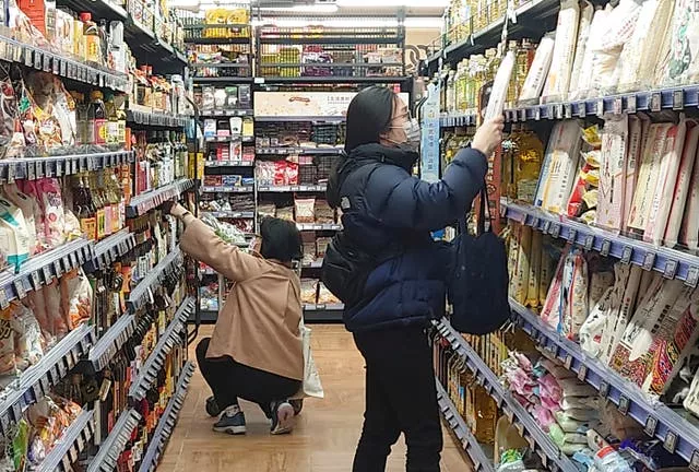 People wear face masks as they shop at a supermarket in Taipei, Taiwan