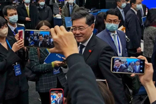 Journalists and delegates film Mr Wang after his speech