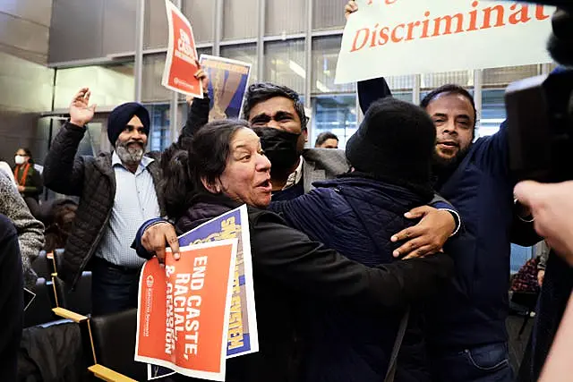 People celebrate the passing of an ordinance