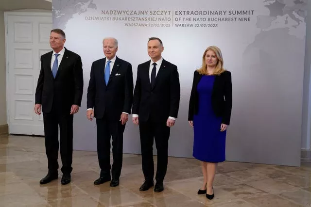 President Joe Biden is greeted by, from left, Romania President Klaus Werner Iohannis, Biden, Polish President Andrzej Duda and Slovakia President Suzana Caputova, right