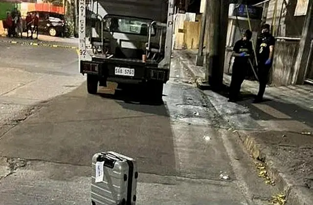 Investigators at the site where New Zealander Nicholas Peter Stacey was shot by robbers in Makati, Philippines