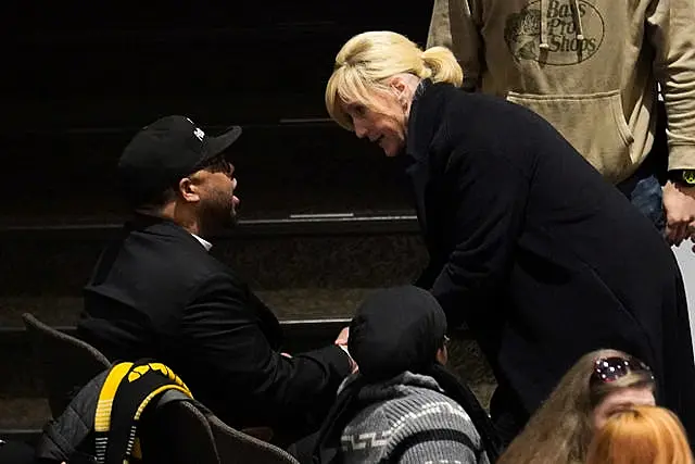 Activist Erin Brockovich talks to a resident of East Palestine before speaking at a town hall meeting at East Palestine High School concerning the February 3 Norfolk Southern freight train derailment in East Palestine, Ohio