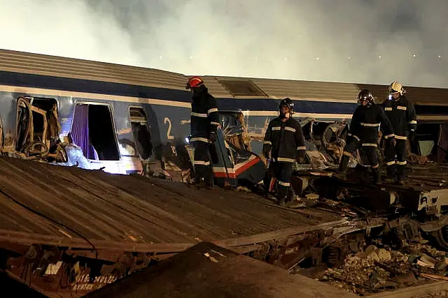 Firefighters operate after a collision in Tempe near Larissa city, Greece early Wednesday, March 1, 2023