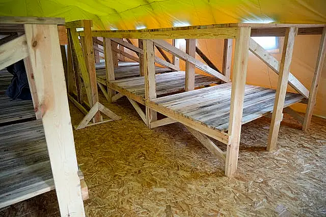 An indoor view of a tent in the Belarusian army camp