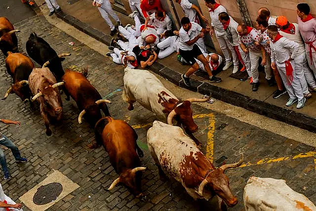 People avoid the bulls in in Pamplona 