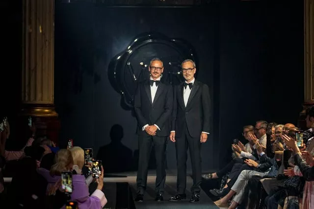 Designers Viktor Horsting, left, and Rolf Snoeren accept applause after the conclusion of the Viktor & Rolf Haute Couture Fall/winter 2023-2024 fashion collection