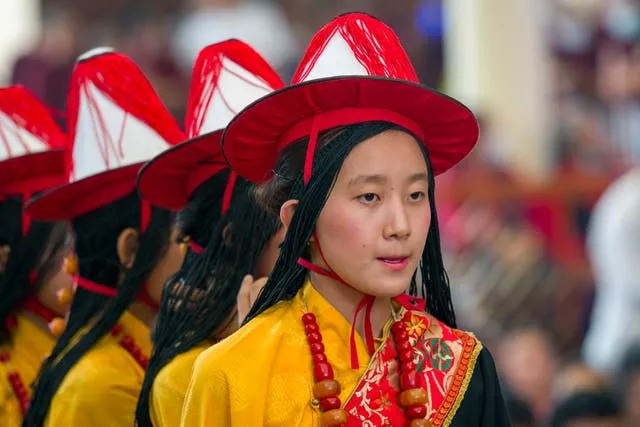 Tibetan children wait to perform at the birthday celebration