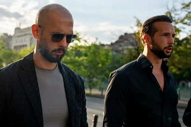 Andrew Tate, left, and his brother Tristan leave the Court of Appeal in Bucharest earlier in July