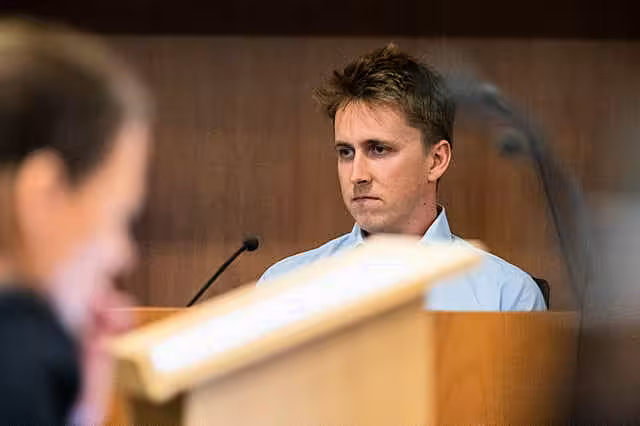 Pilot Brian Depauw reacts in the witness box at the Whakaari White Island eruption trial at the Auckland Environment Court in Auckland, New Zealand