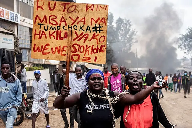 Protesters carry a placard