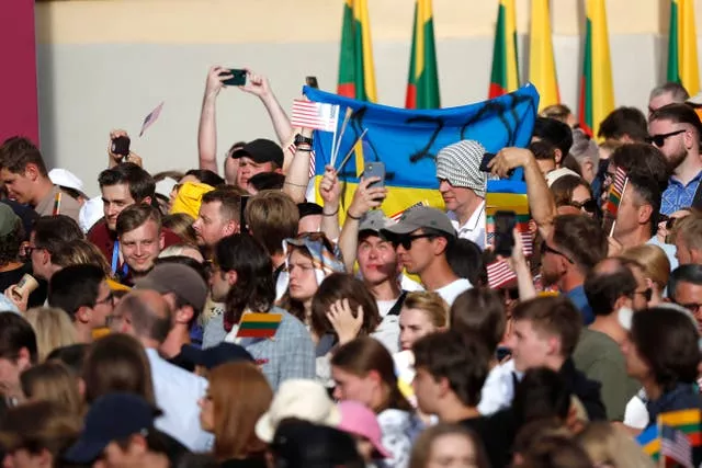 People wave Ukrainian, Lithuanian and American flags