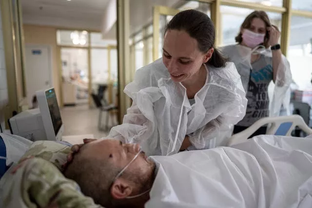 Olena smiles at her husband Maksym, an injured Ukrainian serviceman, at Mechnikov Hospital in Dnipro