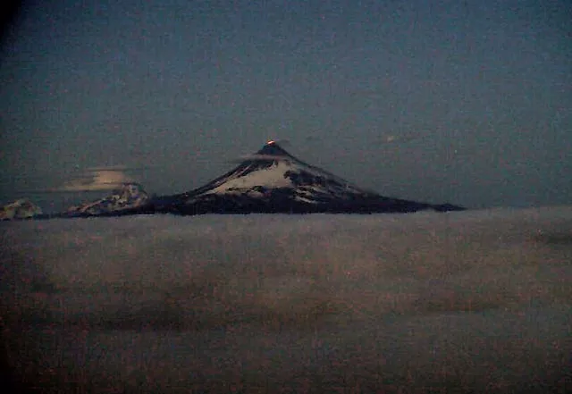 This web camera image provided by the US Geological Survey shows glowing lava erupting within the summit crater of Shishaldin around 12:30 a.m. AKDT, Tuesday, July 18, 2023, as seen from the WTUG webcam located NW of the volcano 